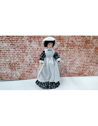 Niñera de porcelana con delantal blanco